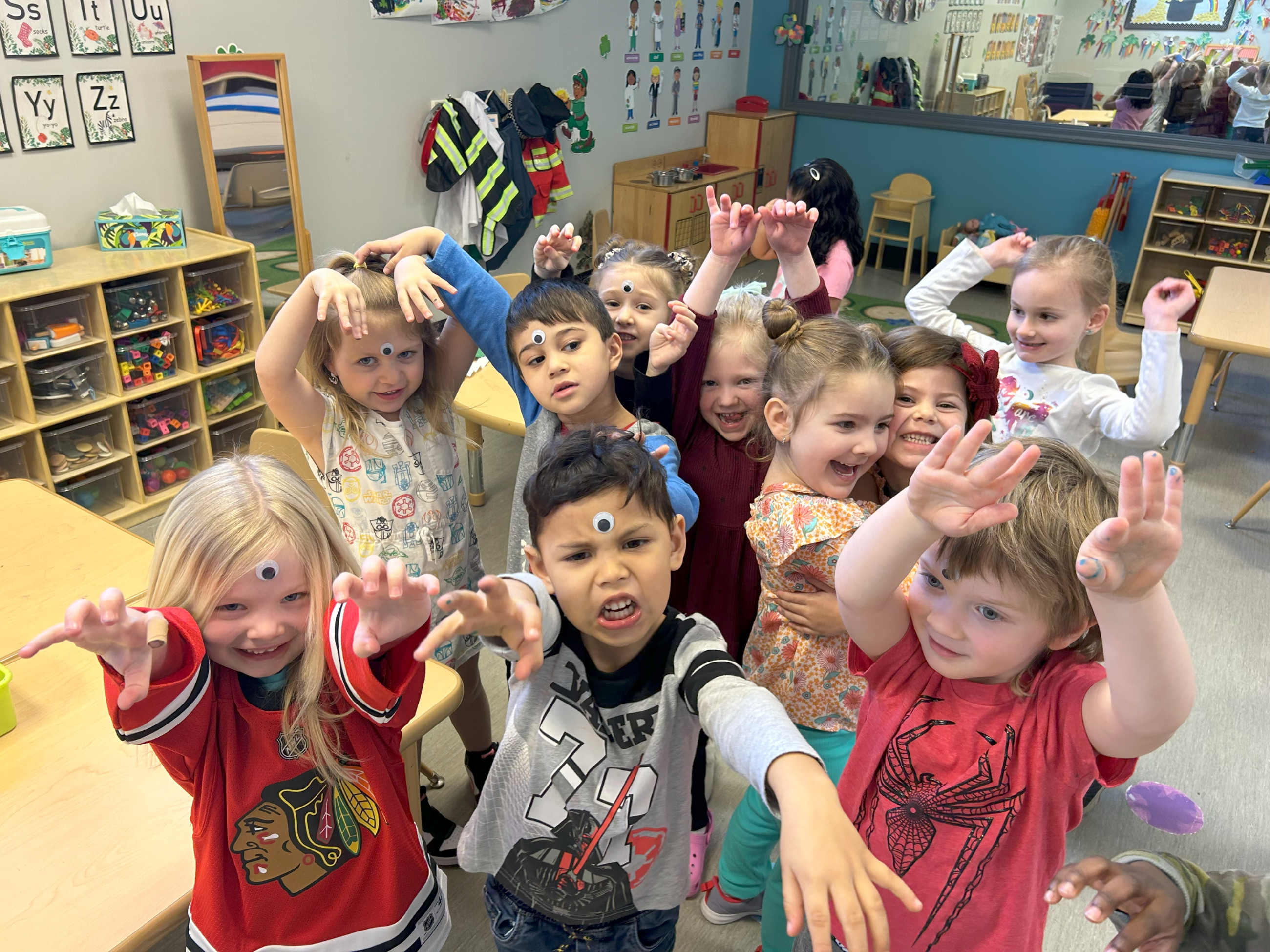 Preschool students having fun with googly eyes.