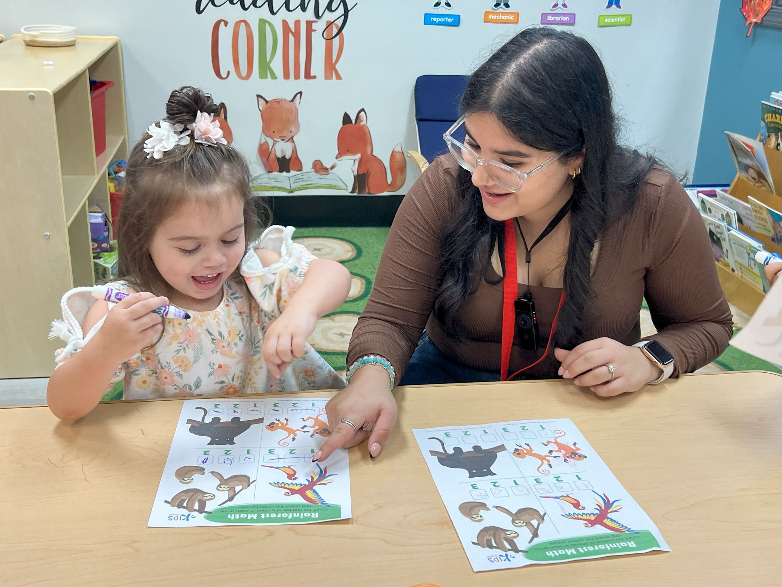 A high school student helping a preschooler learn. 