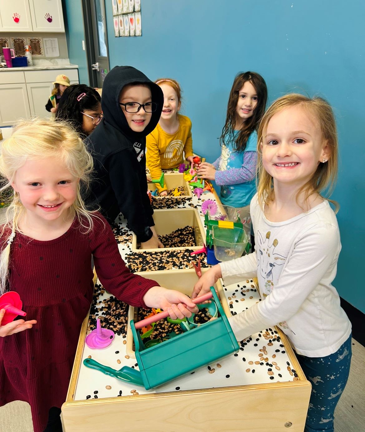 Students playing in a sensory bin.