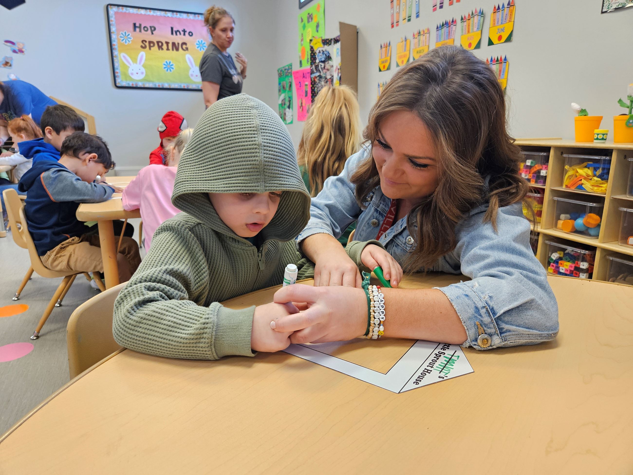 A teacher helping a student with their worksheet. 